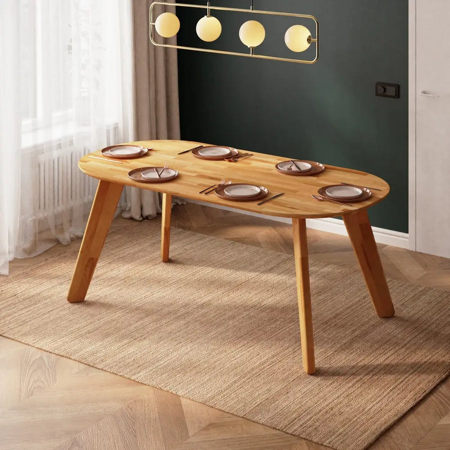 Wide shot of the Monroe oval wood dining table in a contemporary dining space.
