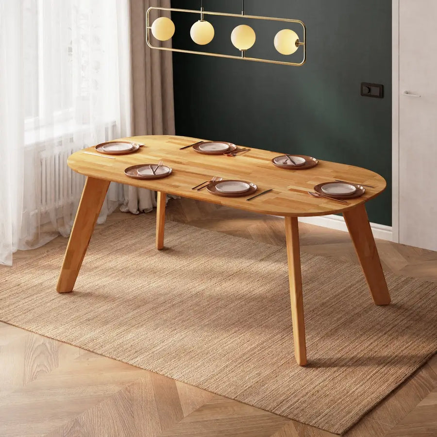 Monroe oval wood dining table set with place settings, featuring its spacious surface perfect for gatherings.
