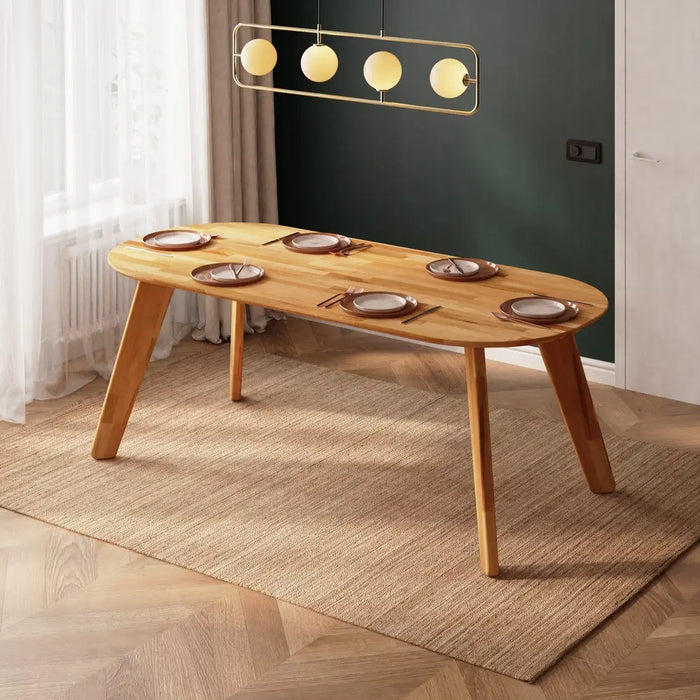 Corner view of the Monroe oval dining table in a bright, airy room, complementing modern décor.