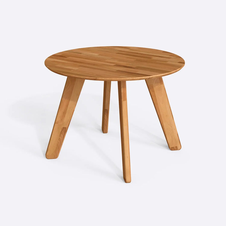 A cozy dining setup featuring the solid wood round kitchen table with minimalist décor accents