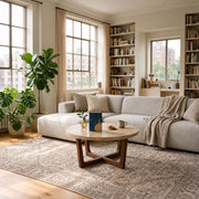 Muse Round Travertine Coffee Table with Walnut Wood Base - Mid-Century Modern Cross Base Design Styled in a Bright Living Room by Tomruque