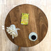 Top view of a solid walnut wood round coffee table, showing the smooth, natural wood grain and round tabletop design.