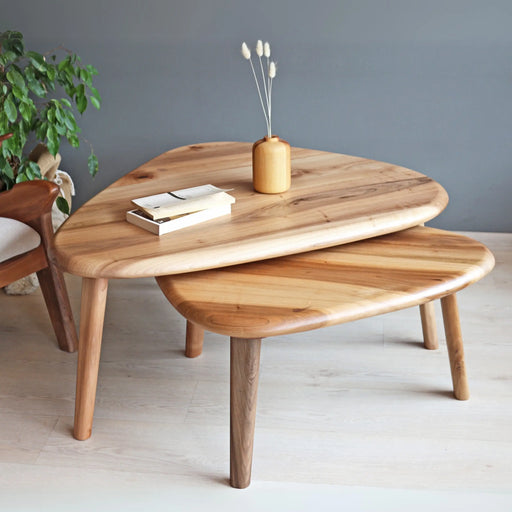 Nova mid-century modern coffee table set, partially stacked, with decor on top, captured from a mid-level angle.