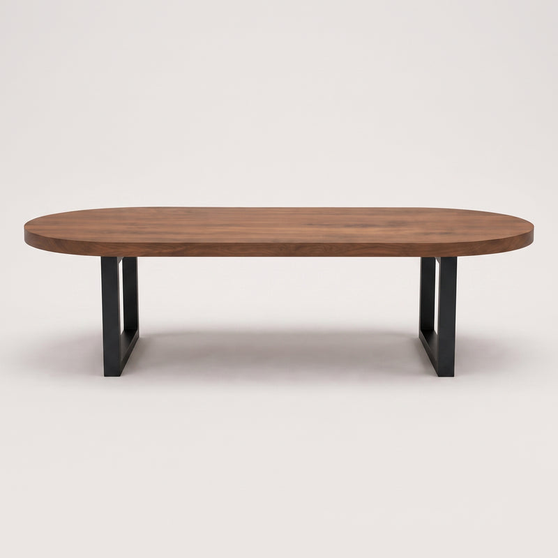 Oasis oval walnut coffee table with a medium brown wood grain top and a black metal frame base, shown against a plain light gray background.
