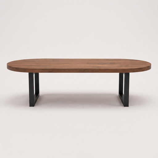 Oasis oval walnut coffee table with a medium brown wood grain top and a black metal frame base, shown against a plain light gray background.