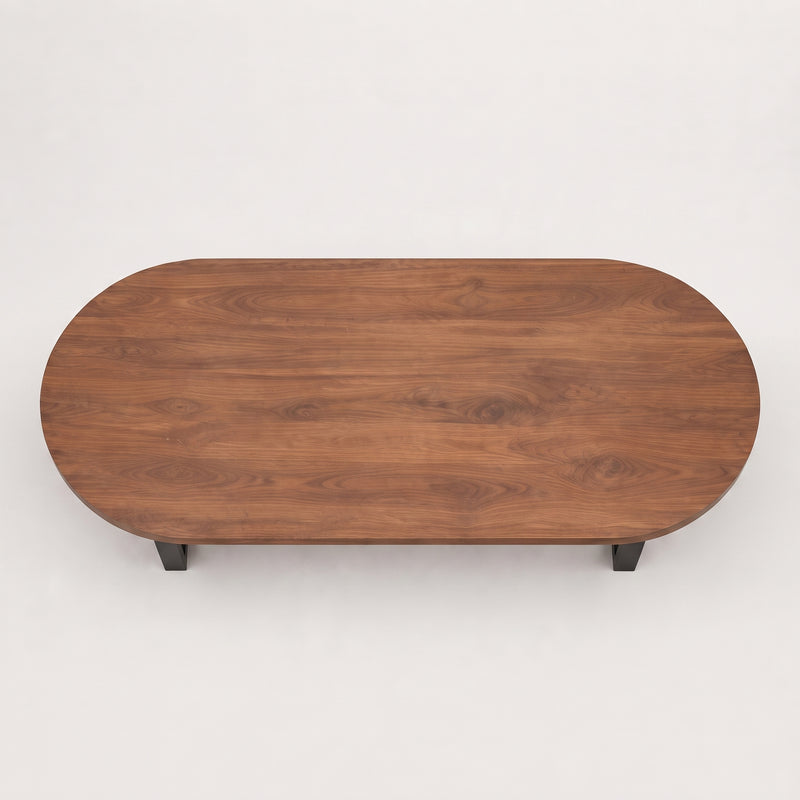 Oasis oval walnut coffee table with a rich walnut wood grain finish and small black metal legs, shown from a top-down perspective