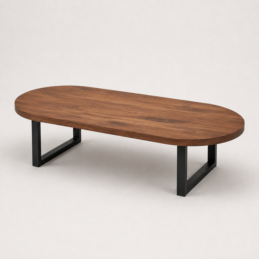 Oasis oval walnut coffee table with a medium brown wood grain top and a black metal frame base, shown on a light gray studio background.