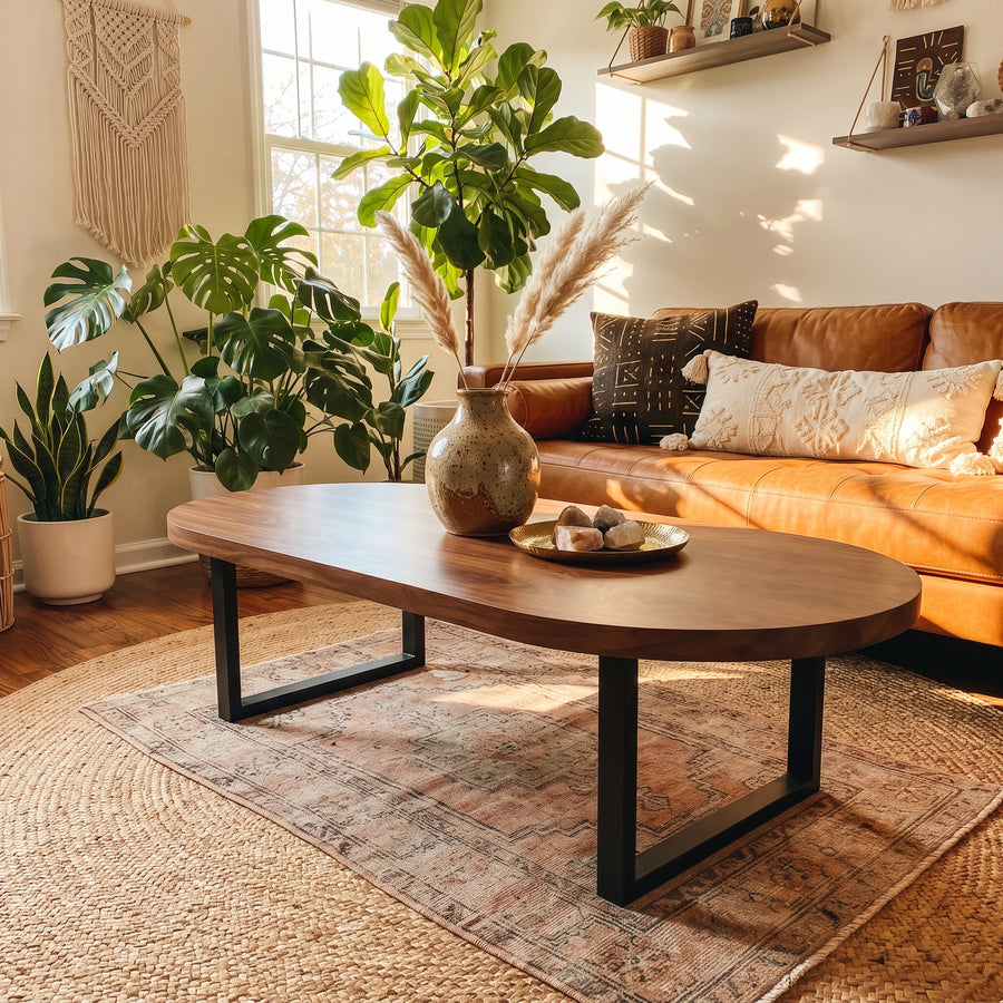 Solid walnut oval coffee table with industrial metal base