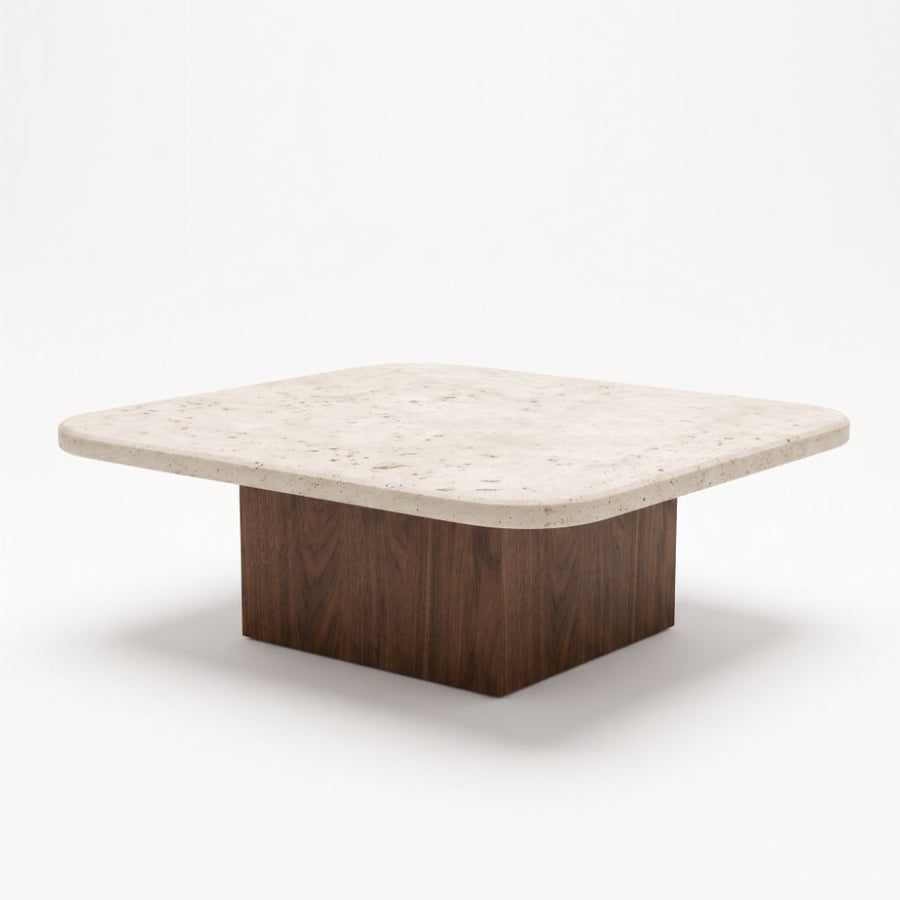Three-quarter studio view of Pera Square Travertine Coffee Table featuring a rounded-corner beige stone top and solid walnut block base