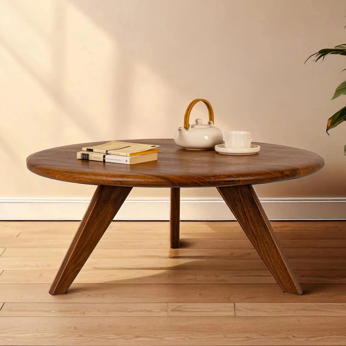 Petra Wood Round Coffee Table, mid century modern designed legs and tabletop, with a warm background