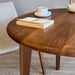 Detail of the table’s base, showing the sturdy walnut wood construction.