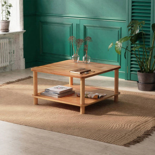 Solid wood coffee table with a storage shelf from a diagonal angle in a hall setting.