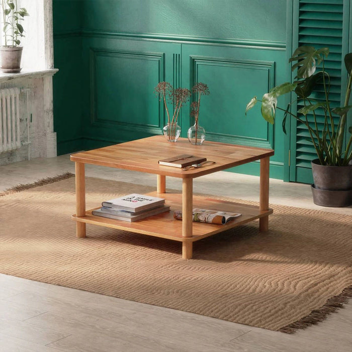 Solid wood coffee table with a storage shelf from a diagonal angle in a hall setting.