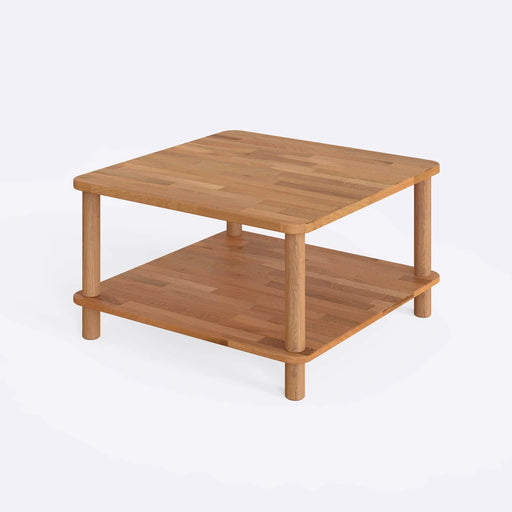 Solid wood coffee table with a storage shelf from a diagonal angle in a white bacground.