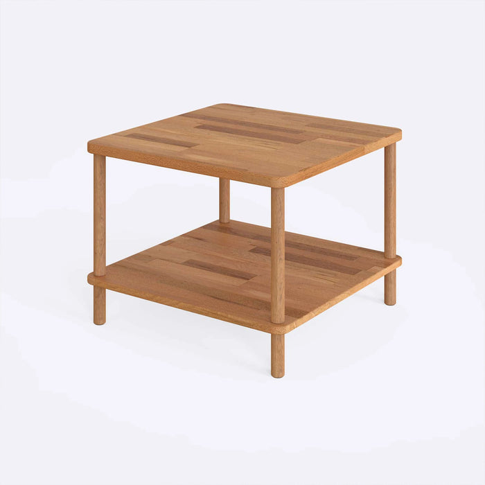 Solid wood coffee table with a storage shelf small size from a diagonal angle on a white bacground.