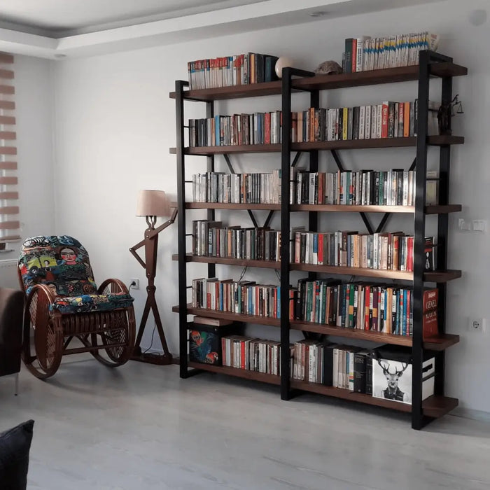 Close-up of the metal frame of the Renton Industrial Bookcase, complementing the solid wood shelves for a cohesive industrial look.