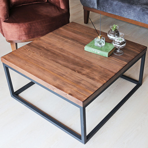 Top-down view of the Renton square wooden coffee table, highlighting the metal legs and clean lines of the table.