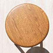 Sidney Round Side Table Solid Oak Wood from directly above, showing a warm medium-brown wood grain finish on a light floor.