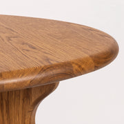 Close-up of Sidney Circular Dining Table Solid Oak Wood – Mid-Century Modern Design corner showing the natural oak wood grain and polished finish against a clean white background.