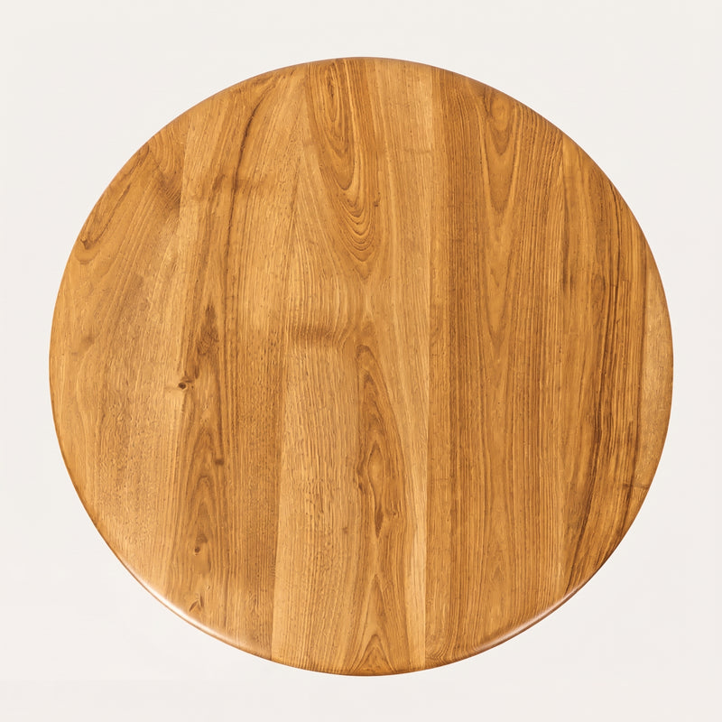 Sidney Circular Dining Table Solid Oak Wood – Mid-Century Modern Design tabletop with a warm medium-brown finish and visible wood grain patterns, photographed from directly above on a light off-white background.