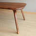 Profile shot of a premium wooden dining table, highlighting its clean proportions and durability.