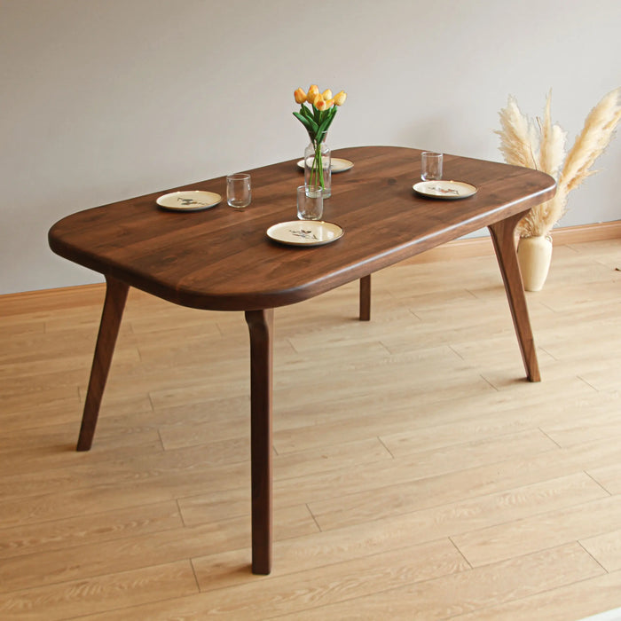 Dining table in a contemporary dining room setup, featuring elegant decor and sturdy wood construction.