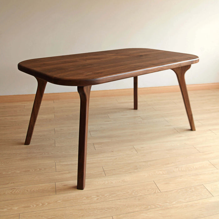 Glossy walnut wood tabletop reflecting light against a bright modern backdrop.