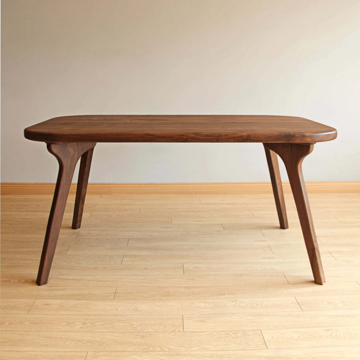 atural lighting emphasizing the warm tones and sleek lines of the hardwood dining table.