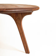 Sidney Round Coffee Table - Solid Walnut Wood - Mid Century Modern Design with a curved, sculptural design and rich medium-brown wood grain, set against a plain white background.
