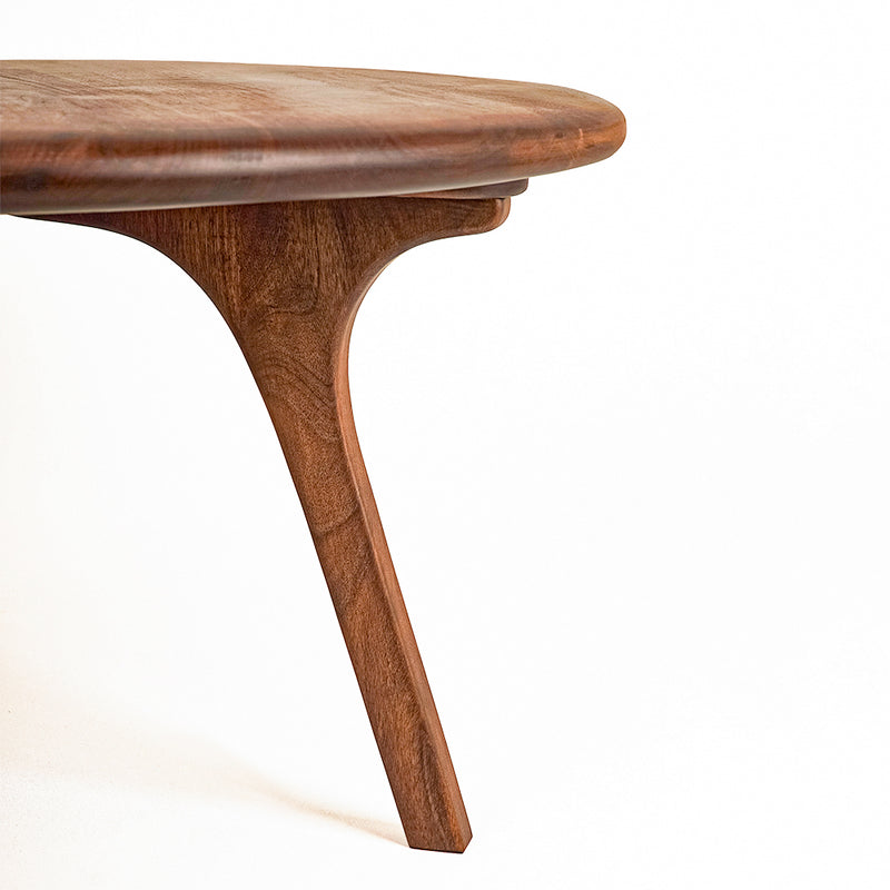 Sidney Round Coffee Table - Solid Walnut Wood - Mid Century Modern Design with a curved, sculptural design and rich medium-brown wood grain, set against a plain white background.