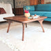 Diagonal view of the Sidney Square Coffee Table, highlighting its elegant solid walnut wood construction and sturdy legs that enhance its mid-century modern design.