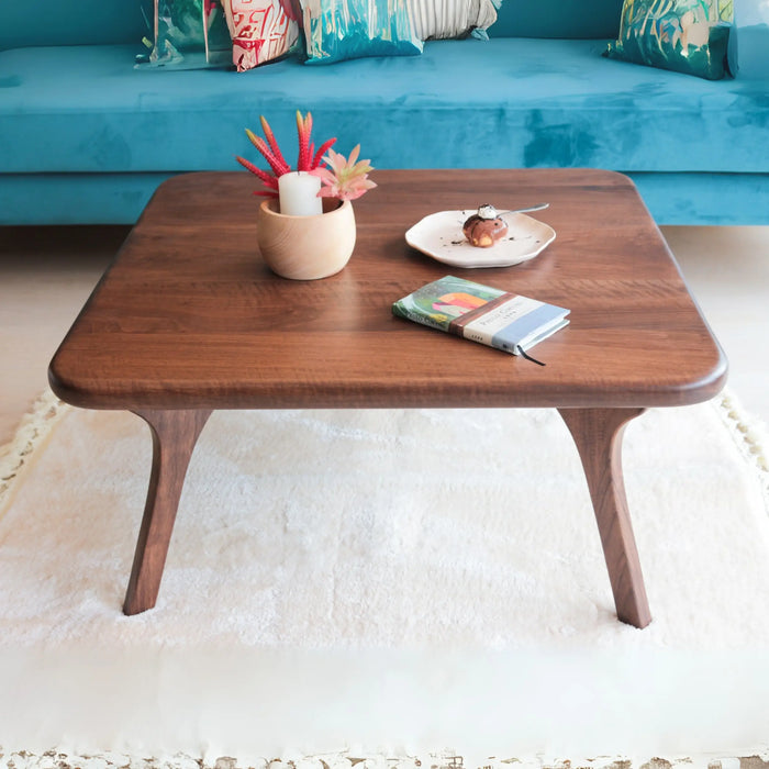 Top front angle of the Sidney Square Coffee Table, showcasing its smooth surface and iconic wooden legs, perfect for any stylish living area.