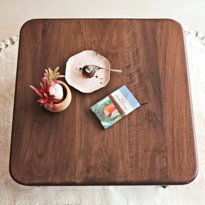 Top view of the Sidney Square Coffee Table, featuring a spacious tabletop design made from solid walnut wood, perfect for displaying decor and everyday use.