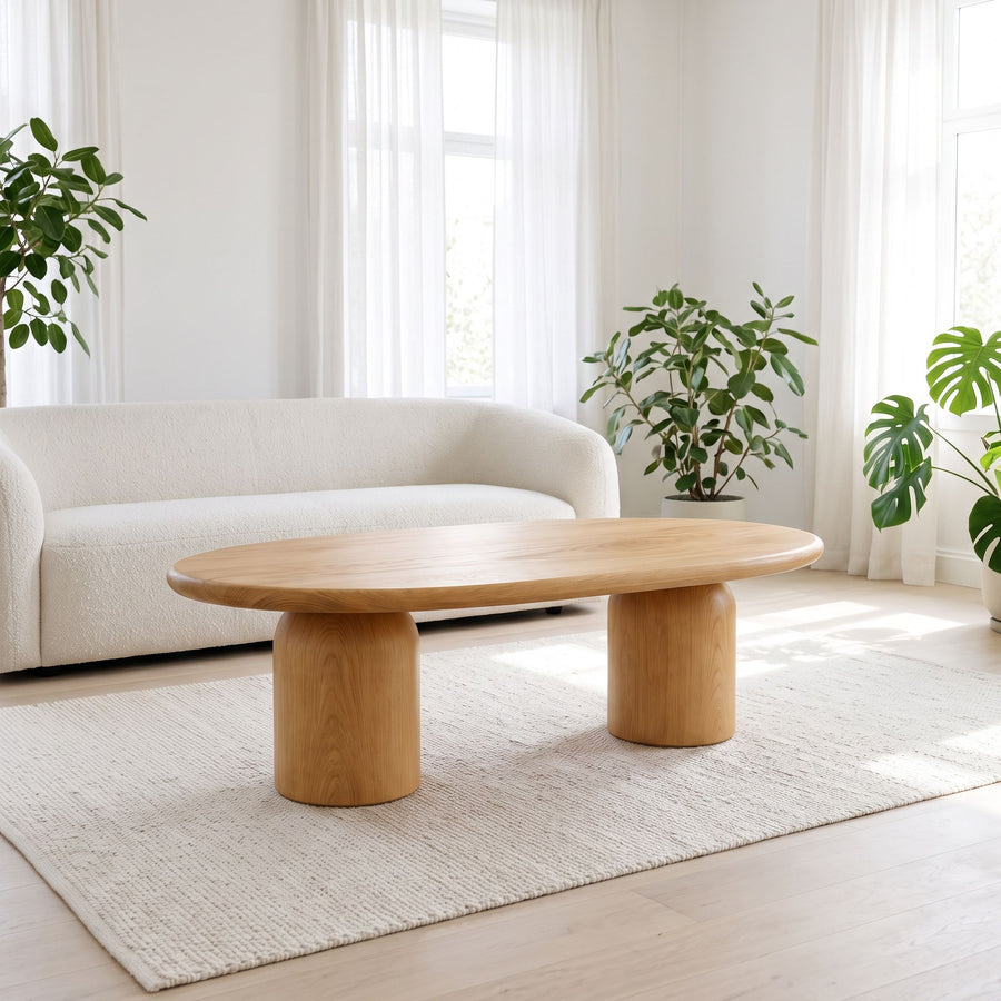 The Solen Oval Coffee Table – Beech Wood Modern Sculptural Design styled in a bright, minimalist living room setup.
