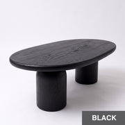 High-angle view of Solen Oval Coffee Table – Beech Wood Modern Sculptural Design in a black finish with thick cylindrical pillar legs.