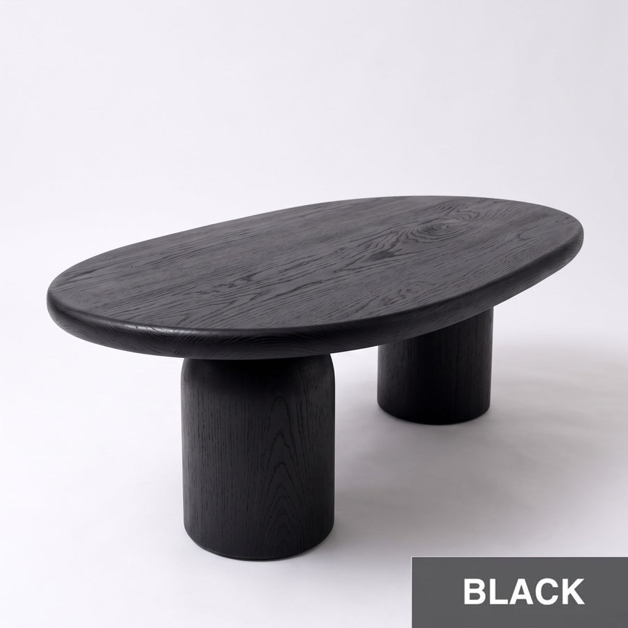 High-angle view of Solen Oval Coffee Table – Beech Wood Modern Sculptural Design in a black finish with thick cylindrical pillar legs.