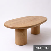 Angular view of Solen Oval Coffee Table – Beech Wood Modern Sculptural Design in natural finish, featuring thick cylindrical pillar legs.