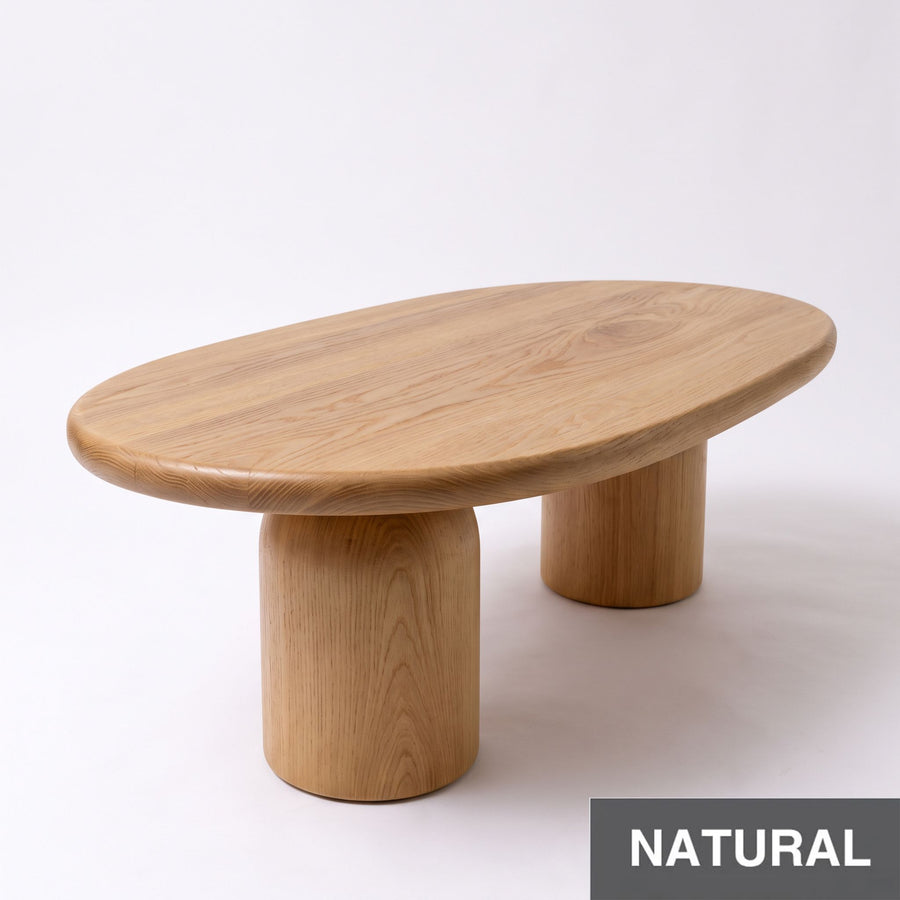 Angular view of Solen Oval Coffee Table – Beech Wood Modern Sculptural Design in natural finish, featuring thick cylindrical pillar legs.