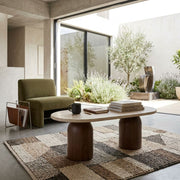 Solen Oval Travertine Coffee Table with Walnut Wood Base - Sculptural Organic Modern Design Styled in a Modern Courtyard Living Space by Tomruque