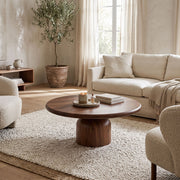 Solen Round Solid Walnut Pedestal Coffee Table Walnut in an Organic Modern Living Room Setup with Bouclé Chairs