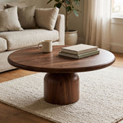 Solen Round Solid Walnut Coffee Table in Walnut Finish Styled with Books and Ceramic Mug in a Cozy Japandi Living Room