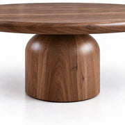 Detailed view of Natural Solid Walnut Wood Grain on the Sculptural Cylindrical Base of Solen Round Coffee Table