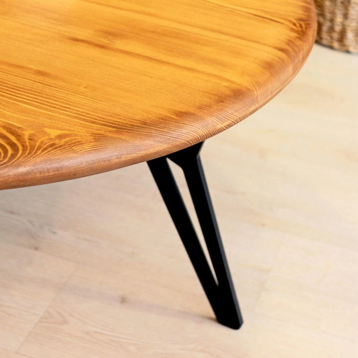 Top-down view of the coffee table, showing its spacious round surface with a flawless wood finish.