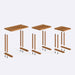 Solid wood nesting table in a living room setting – The C-shaped table placed beside a sofa, highlighting its functional and space-saving design.