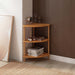 Full view of Webb Wood Corner Bookcase, showing all three shelves neatly filled with books and decor.
