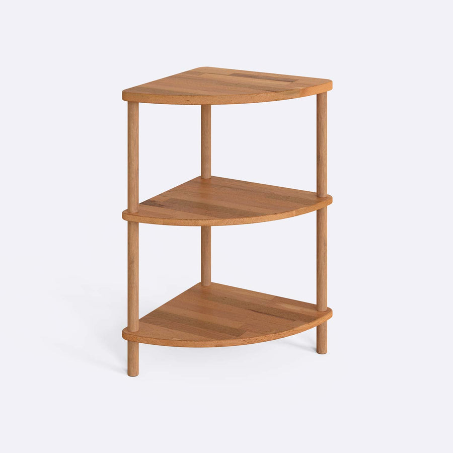 Side view of Webb Wood Corner Bookcase with three spacious shelves, placed in a modern living room corner