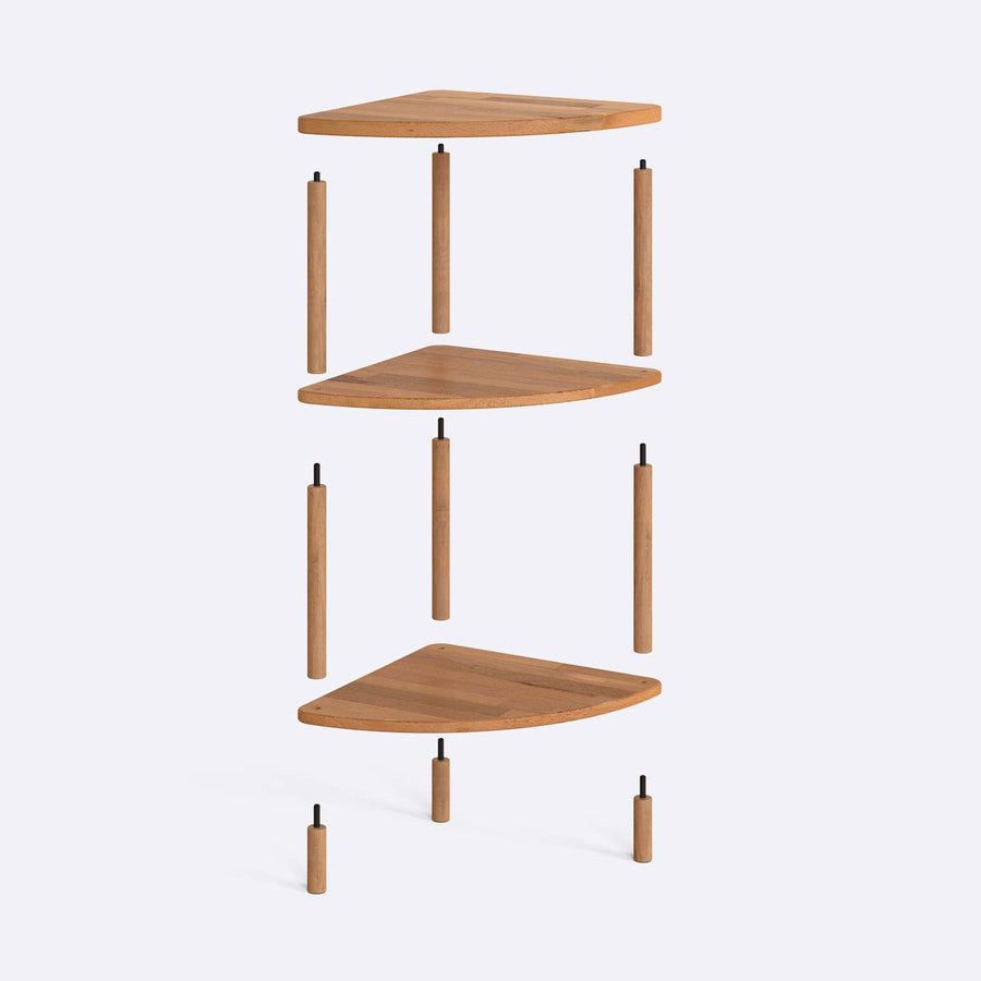 Close-up of the corner of Webb Wood Corner Bookcase, highlighting the smooth finish and natural wood tones.