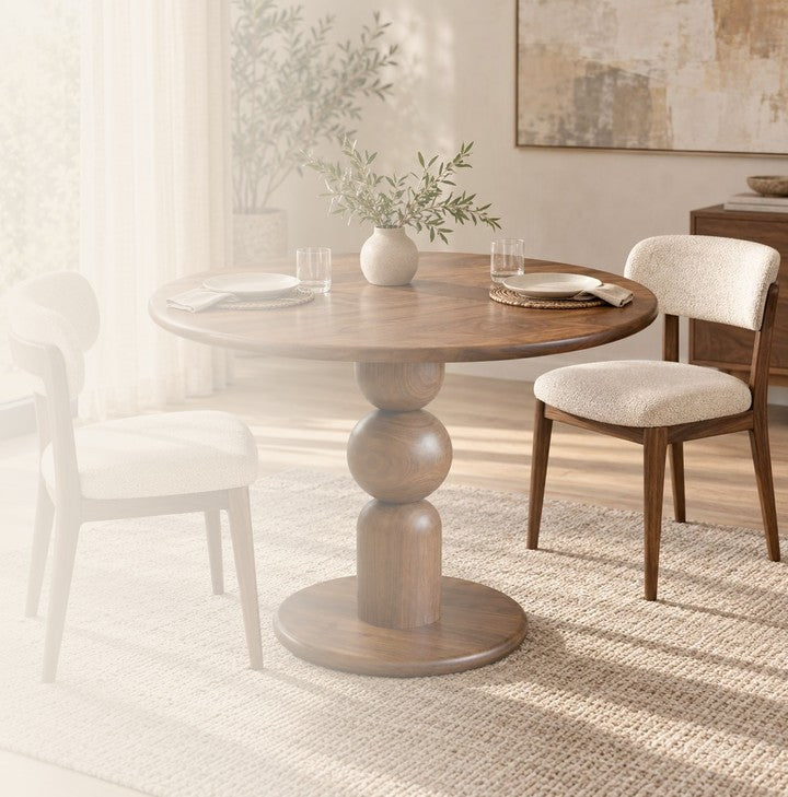 Dorel round walnut pedestal dining table with two upholstered chairs in a sunlit dining room
