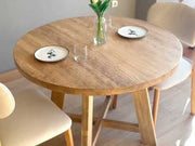 Demonstration of the Amber Round Farmhouse Dining Table, showcasing its functionality and style in various spaces.