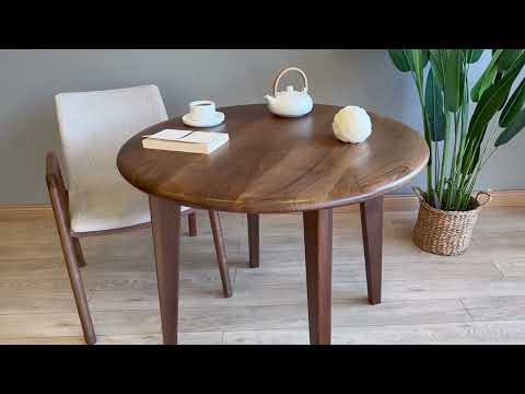 A 360-degree video showcasing the Petra round wood dining room table’s walnut wood finish, mid-century modern design, and versatile placement in various interior styles.